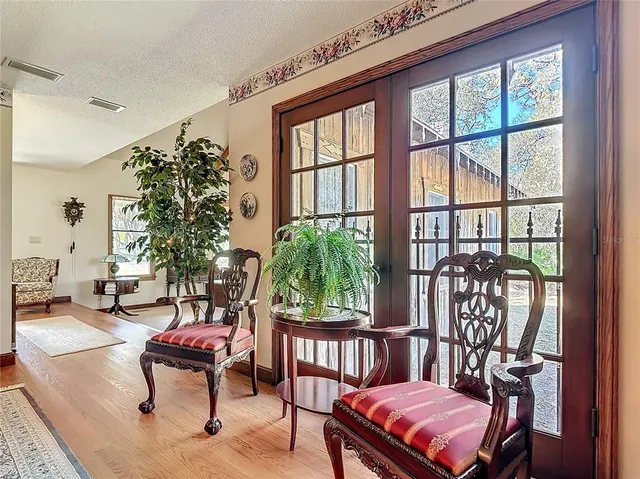 a room with stainless steel appliances kitchen island granite countertop furniture and a view of kitchen