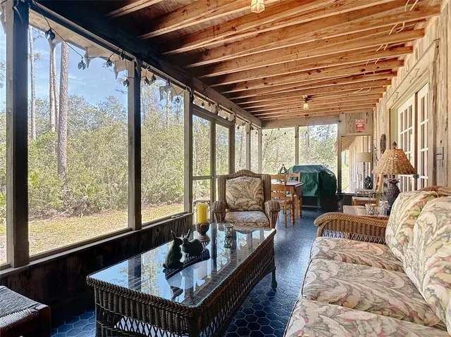 a living room with furniture and a floor to ceiling window