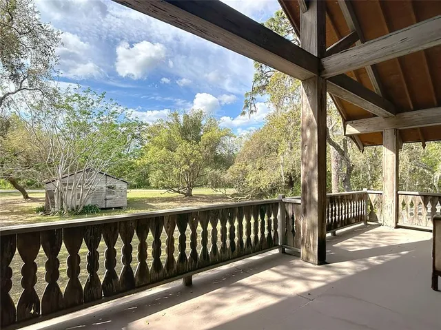 a front view of a house with swimming pool having outdoor seating