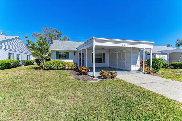 a front view of a house with sitting area and garden