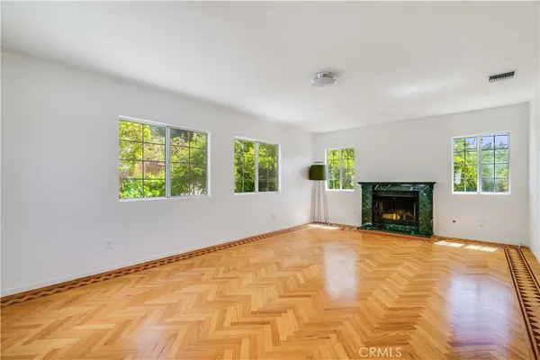 a view of an empty room with window and fireplace