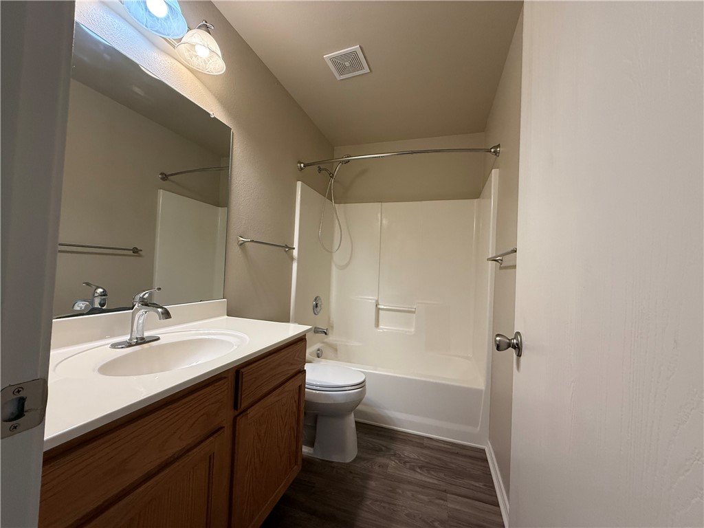1207 Sacramento Street Portland, TX 78374 - Photo 11 of 22 a bathroom with a sink a toilet a shower and a mirror