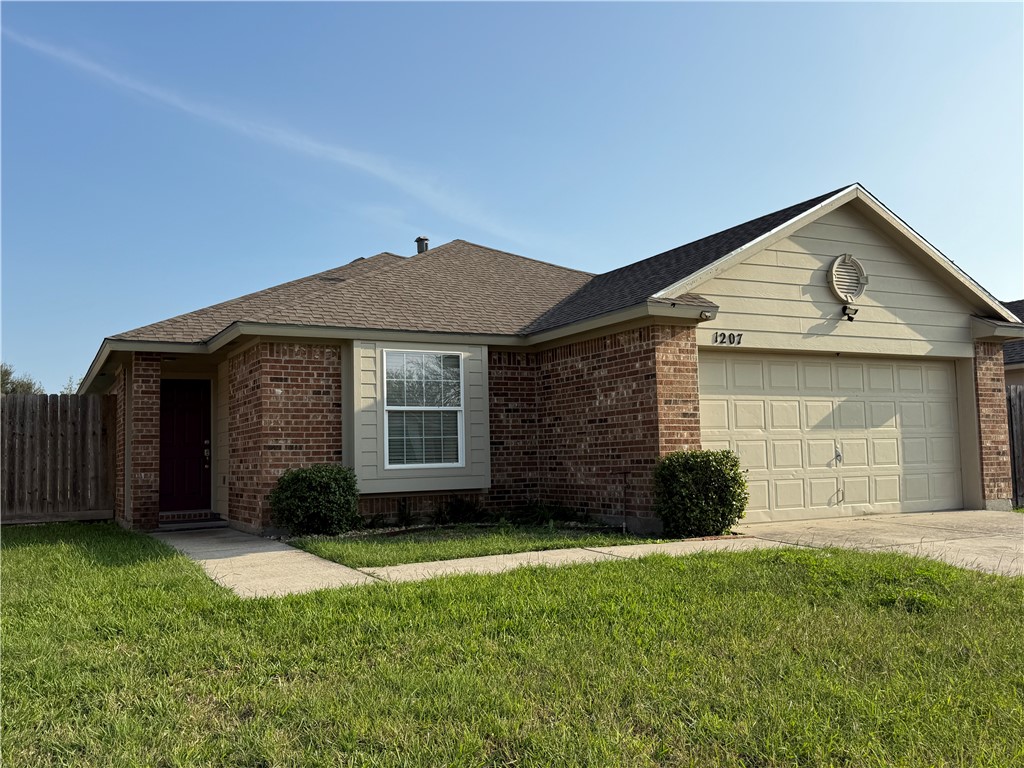 1207 Sacramento Street Portland, TX 78374 - Photo 2 of 22 a front view of a house with a yard