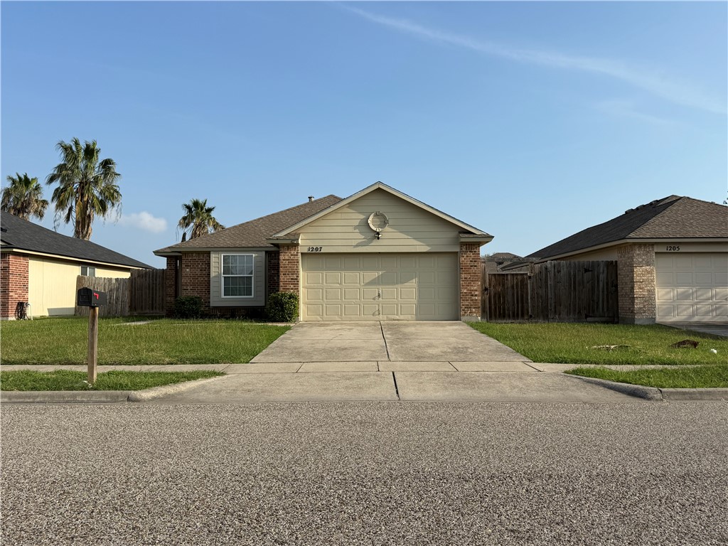 1207 Sacramento Street Portland, TX 78374 - Photo 22 of 22 a front view of a house with a yard and garage