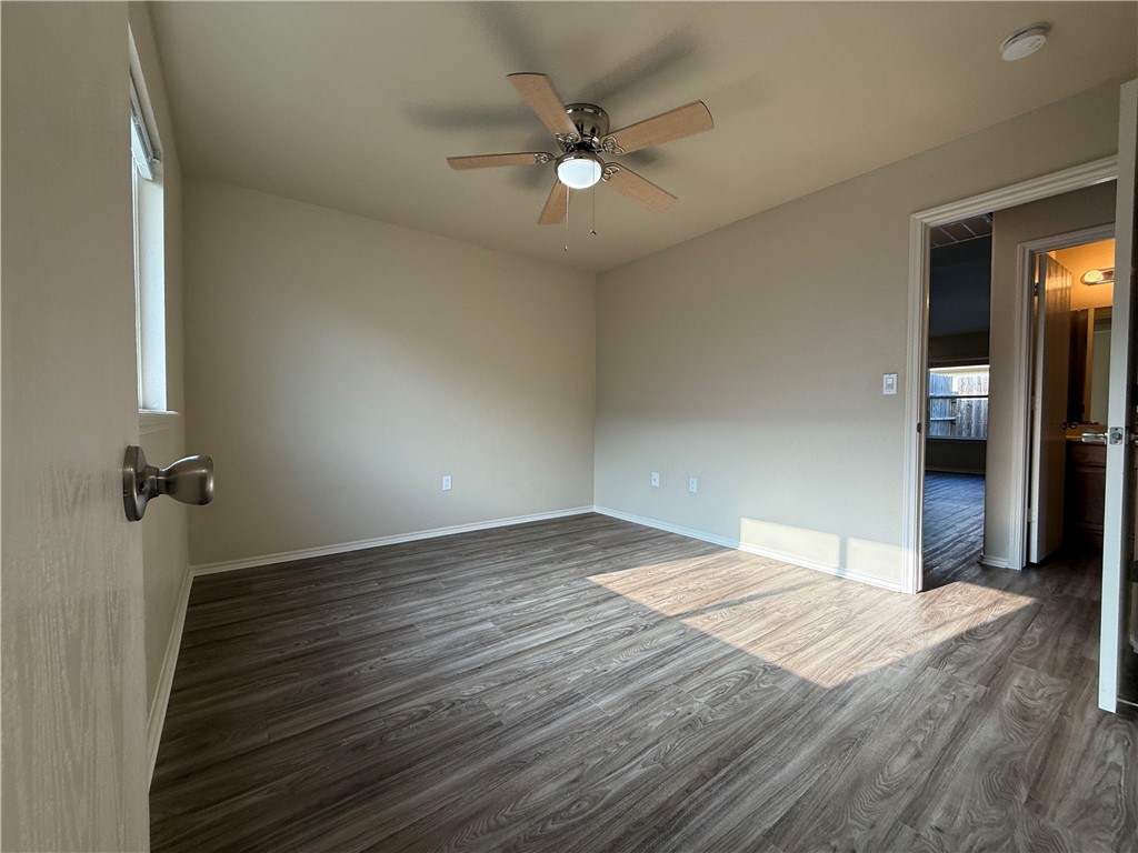 1207 Sacramento Street Portland, TX 78374 - Photo 7 of 22 wooden floor in an empty room with a window