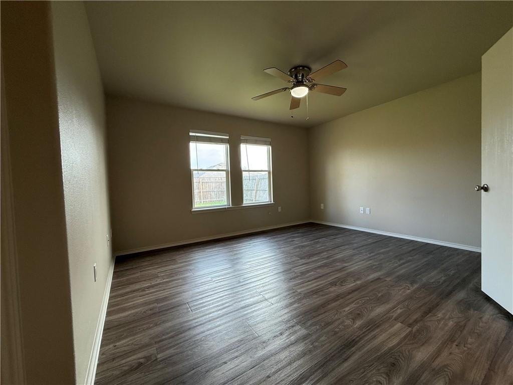 1207 Sacramento Street Portland, TX 78374 - Photo 10 of 22 a view of an empty room with wooden floor and a window