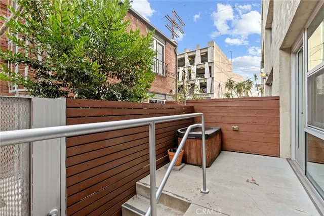 a view of a chairs and table in the balcony