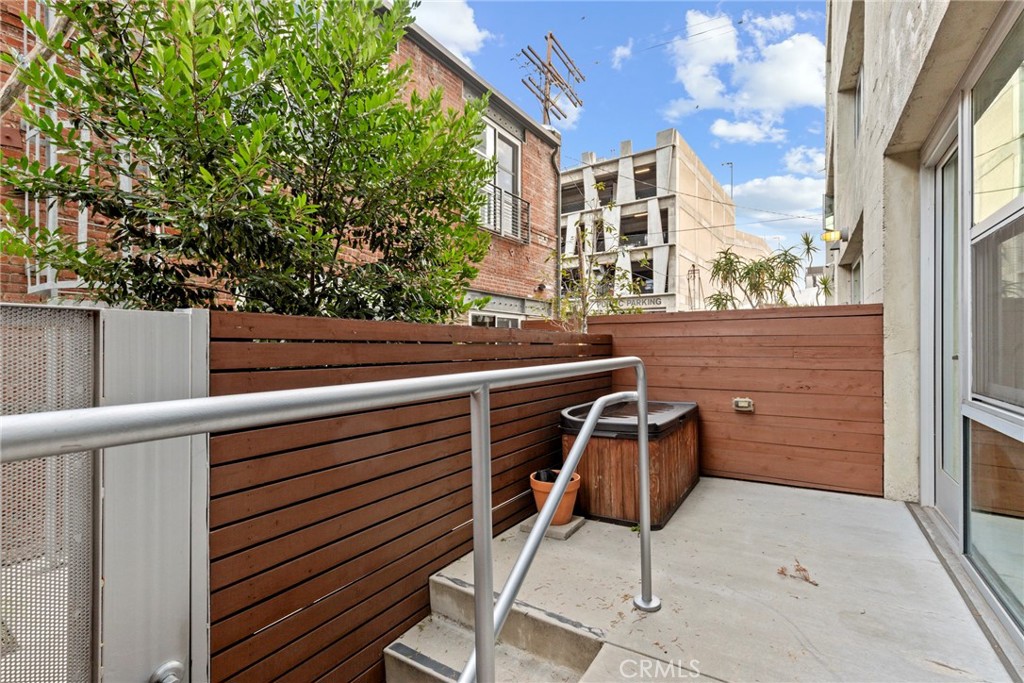 a view of a chairs and table in the balcony