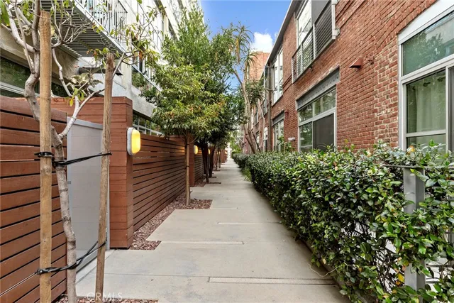 a pathway of a house with a yard