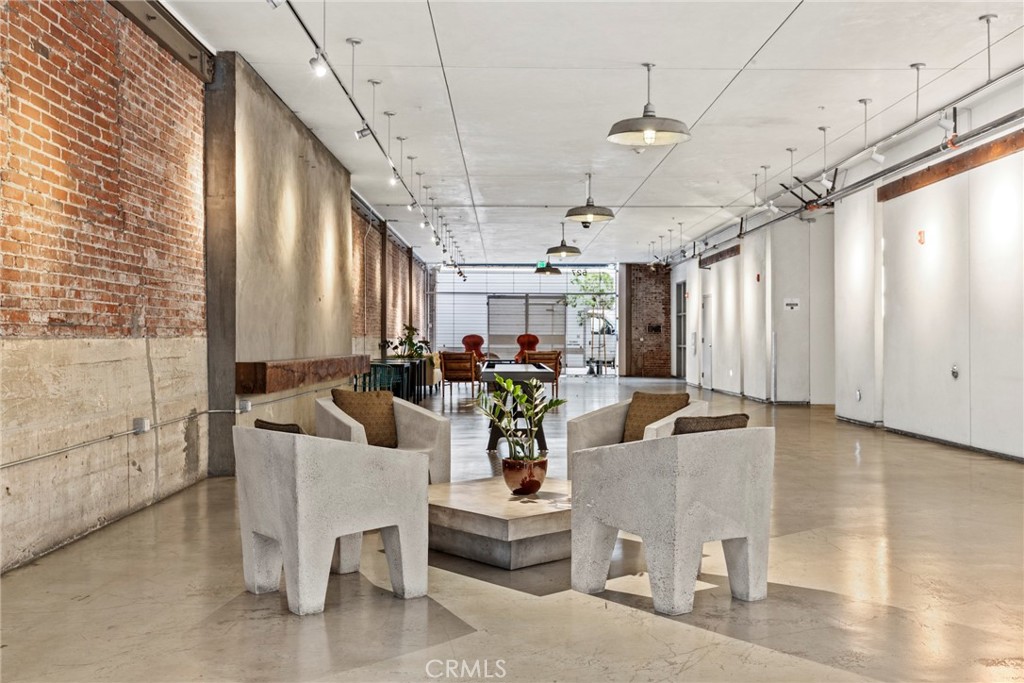 530 South Hewitt Street, Unit 154 Los Angeles, CA 90013 - Photo 27 of 32 a living room with furniture and a chandelier
