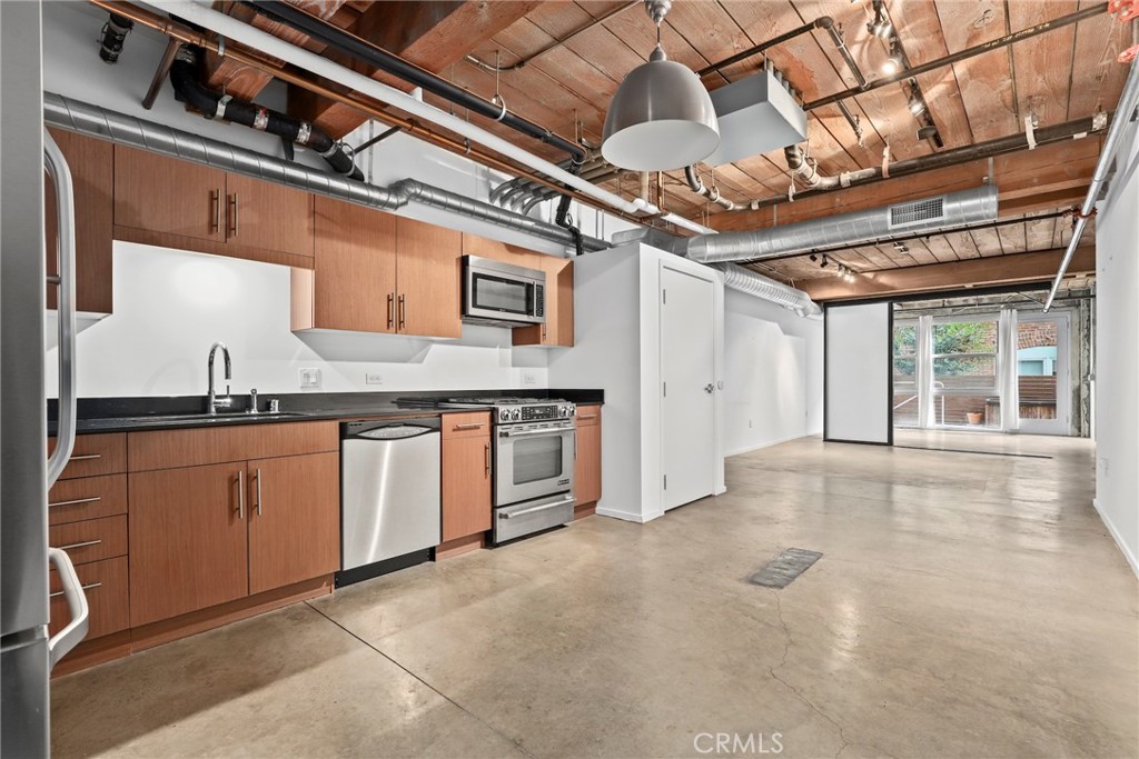 530 South Hewitt Street, Unit 154 Los Angeles, CA 90013 - Photo 10 of 32 a view of a kitchen with stainless steel appliances granite countertop a sink and cabinets
