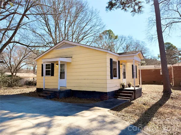 a front view of a house with a yard covered in snow