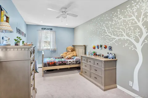 a bedroom with furniture and baby crib