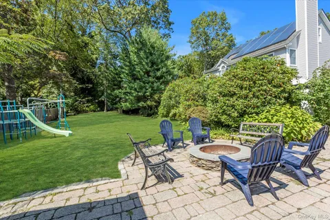 a view of a house with backyard and sitting area