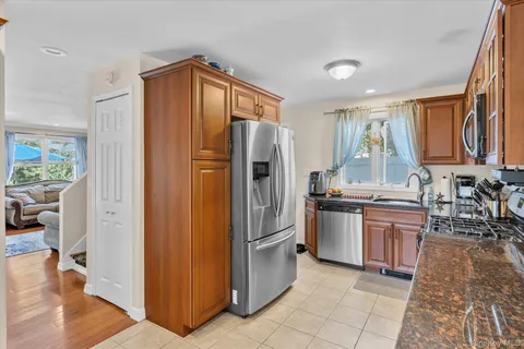 a kitchen with stainless steel appliances granite countertop a refrigerator and a sink