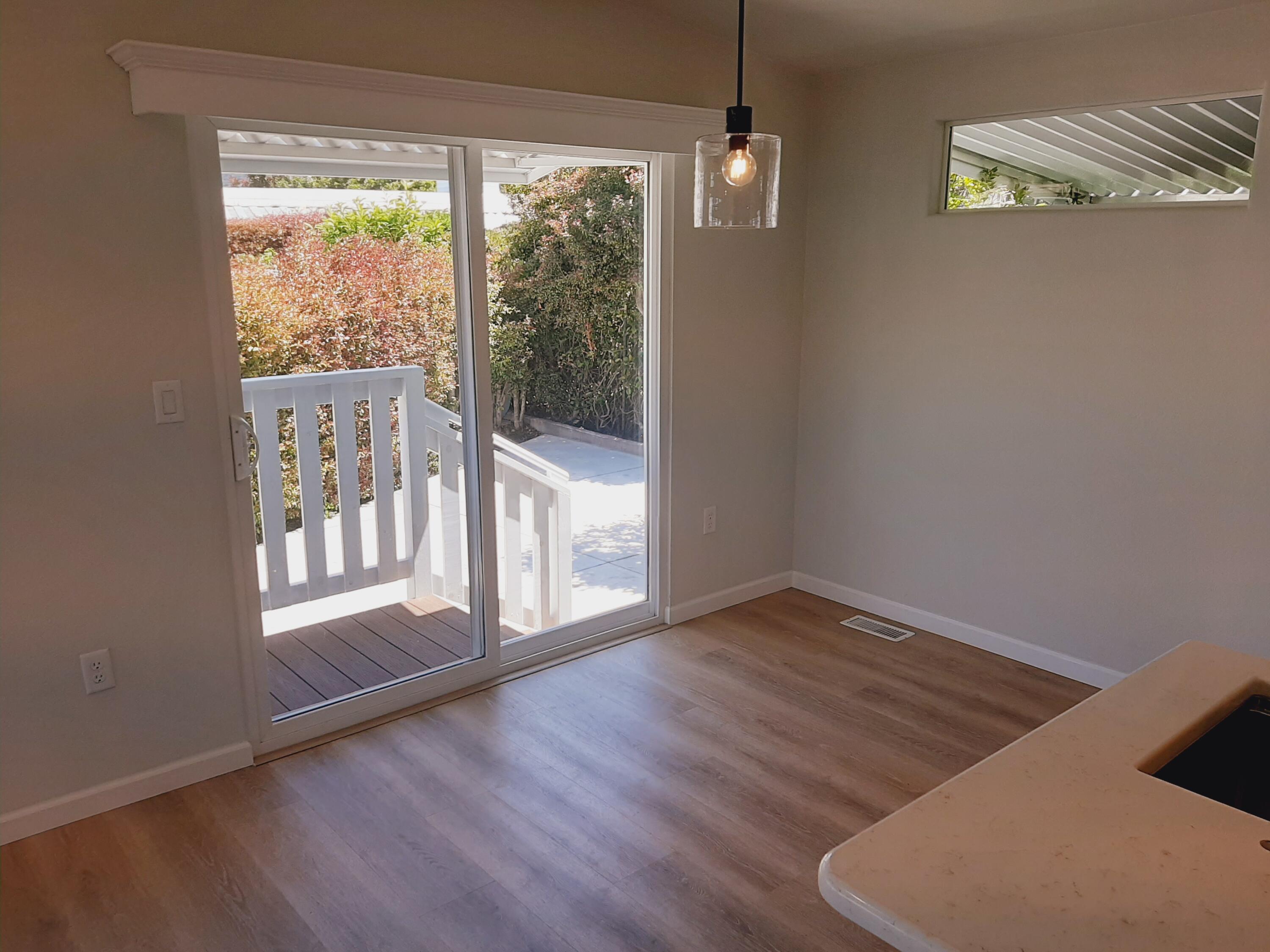333 Old Mill Road, Unit 52 Santa Barbara, CA 93110 - Photo 11 of 29 a view of an empty room with wooden floor and a window