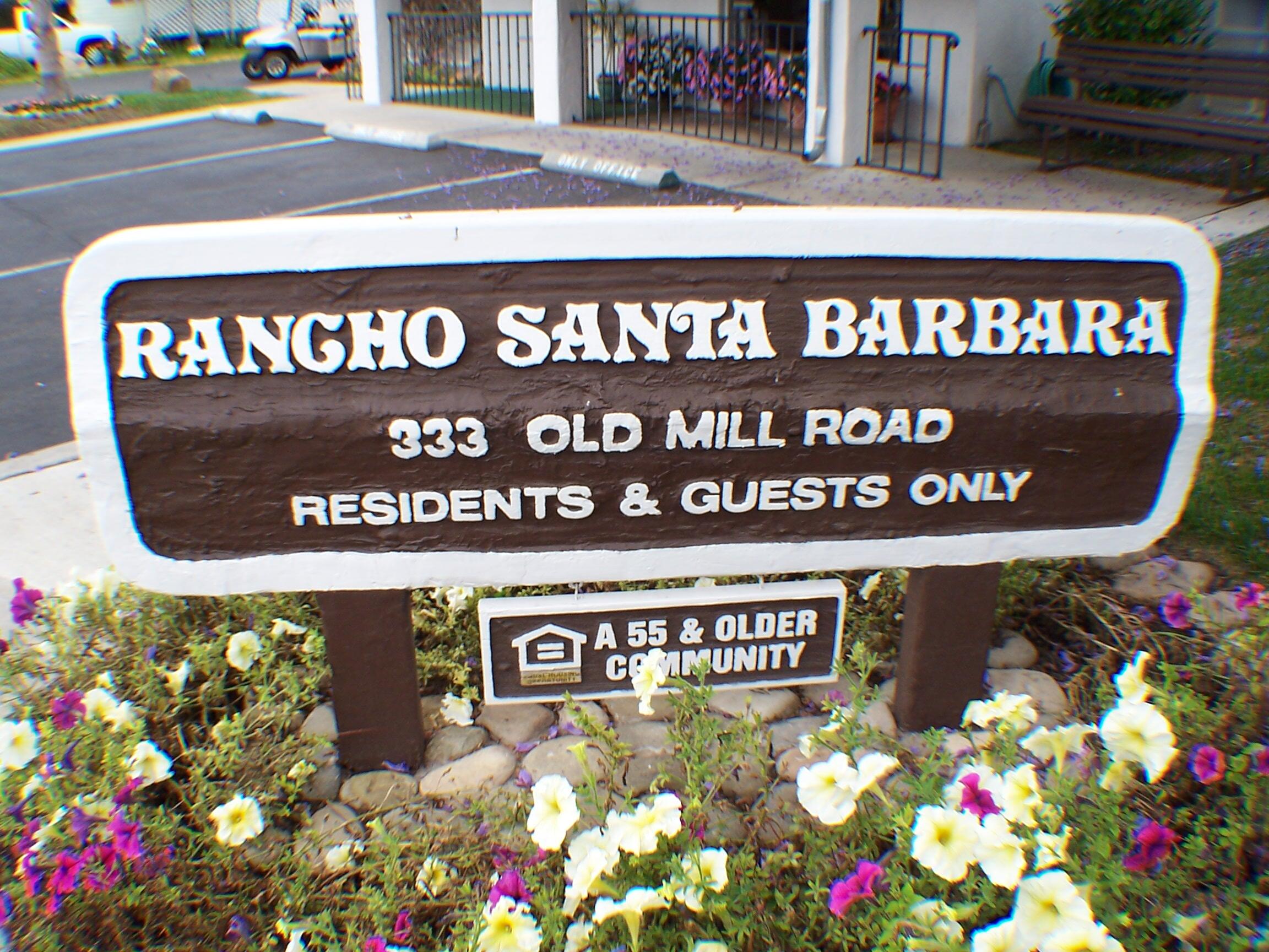 333 Old Mill Road, Unit 52 Santa Barbara, CA 93110 - Photo 25 of 29 a street sign that is sitting in front of flowers