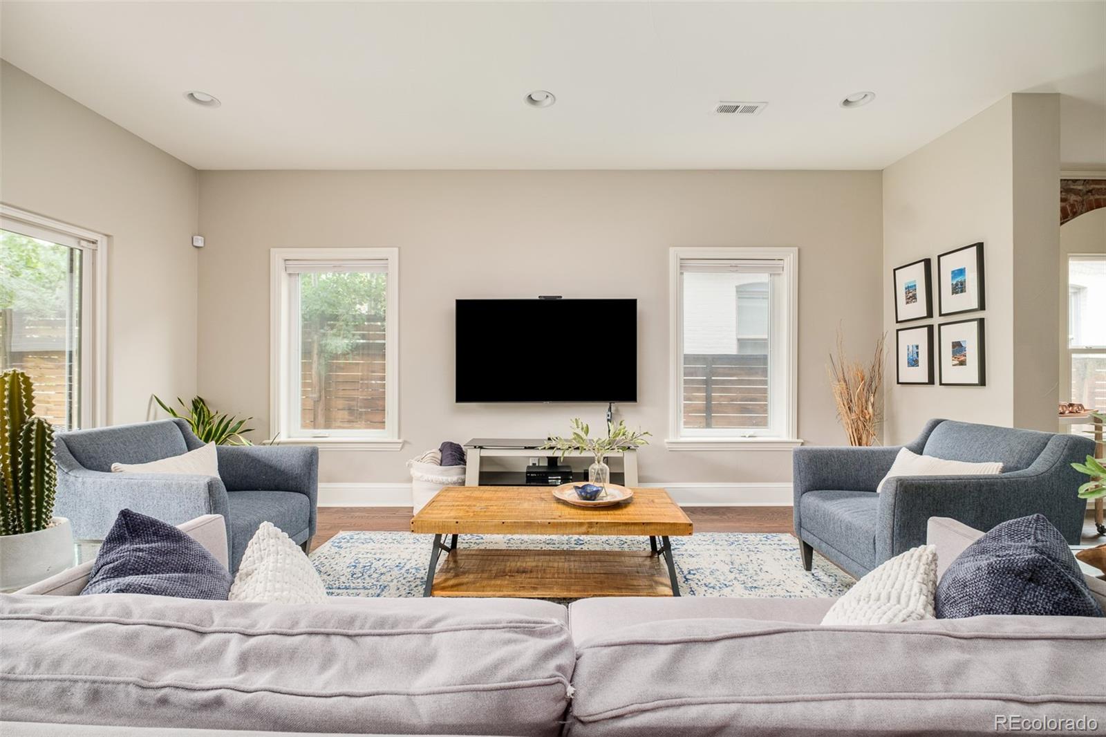 3864 Osceola Street Denver, CO 80212 - Photo 11 of 43 a living room with furniture and a flat screen tv