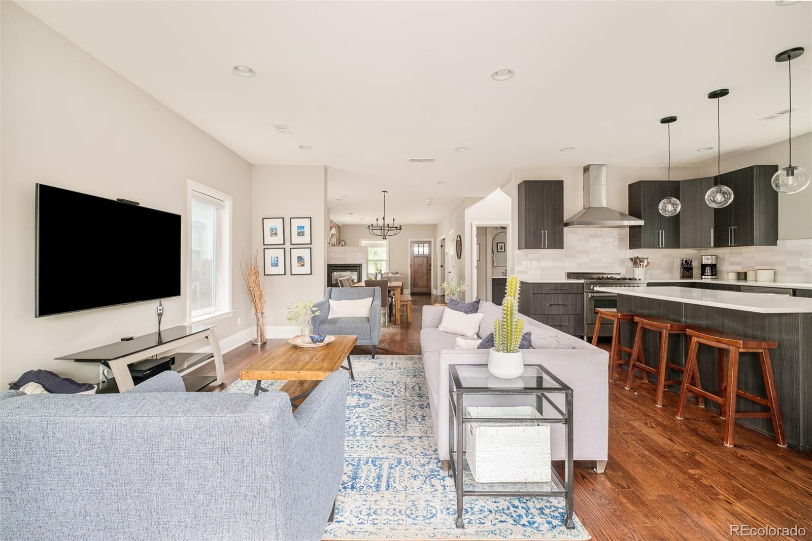 3864 Osceola Street Denver, CO 80212 - Photo 14 of 43 a living room with furniture and a flat screen tv