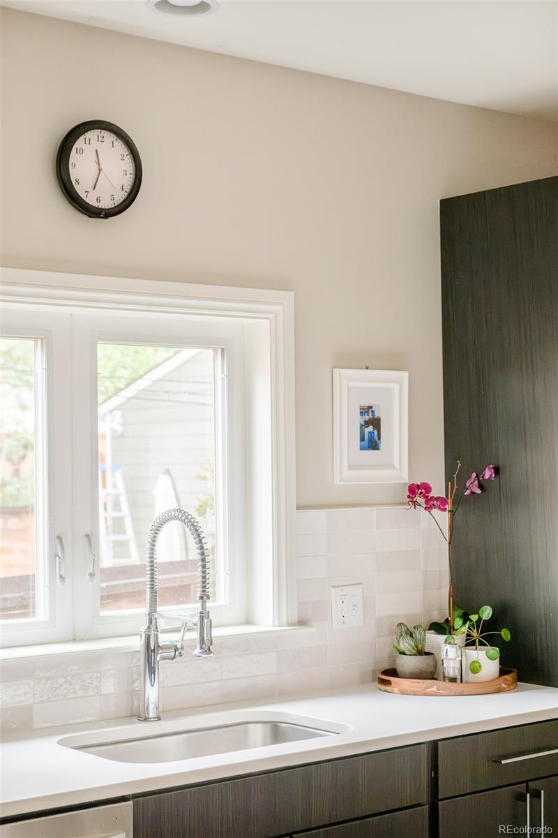 3864 Osceola Street Denver, CO 80212 - Photo 18 of 43 a sink with a mirror and vanity