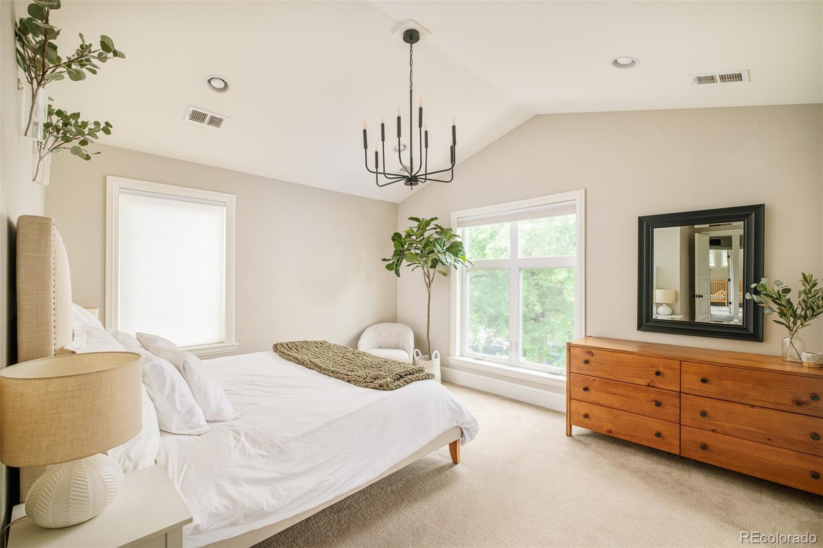 3864 Osceola Street Denver, CO 80212 - Photo 23 of 43 a bedroom with a bed and a chandelier