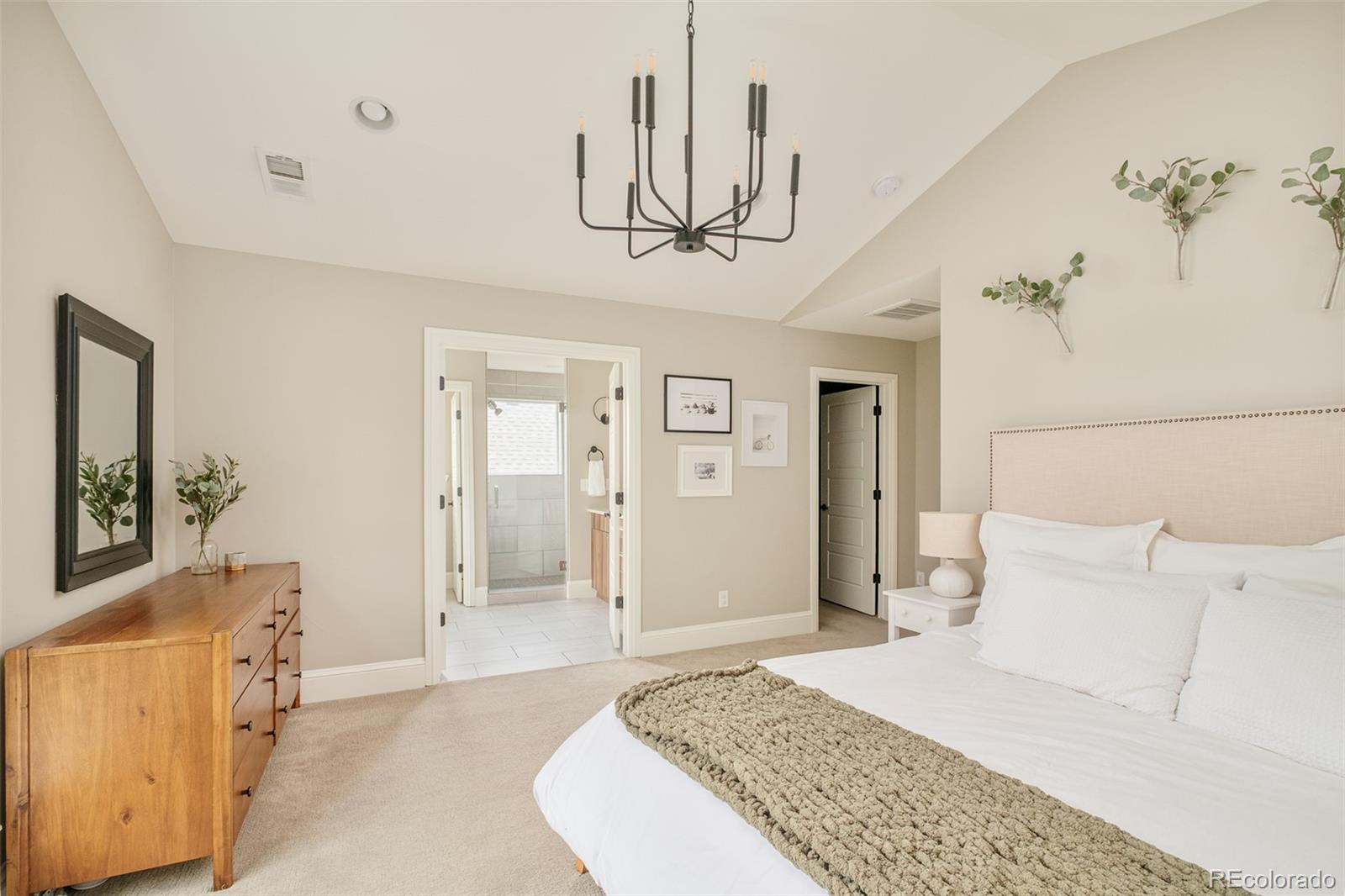 3864 Osceola Street Denver, CO 80212 - Photo 25 of 43 a bedroom with a bed and a chandelier