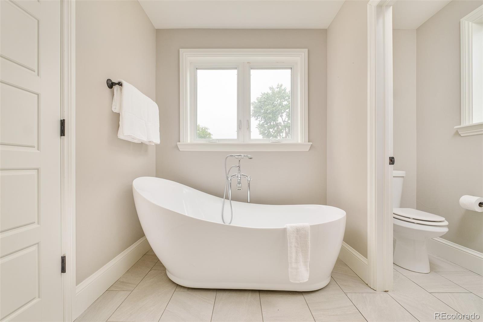 3864 Osceola Street Denver, CO 80212 - Photo 28 of 43 a white bath tub sitting next to a white toilet