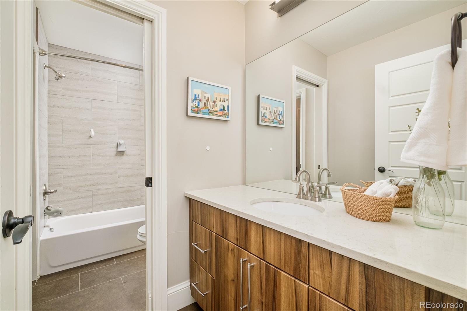 3864 Osceola Street Denver, CO 80212 - Photo 32 of 43 a bathroom with a sink and a mirror