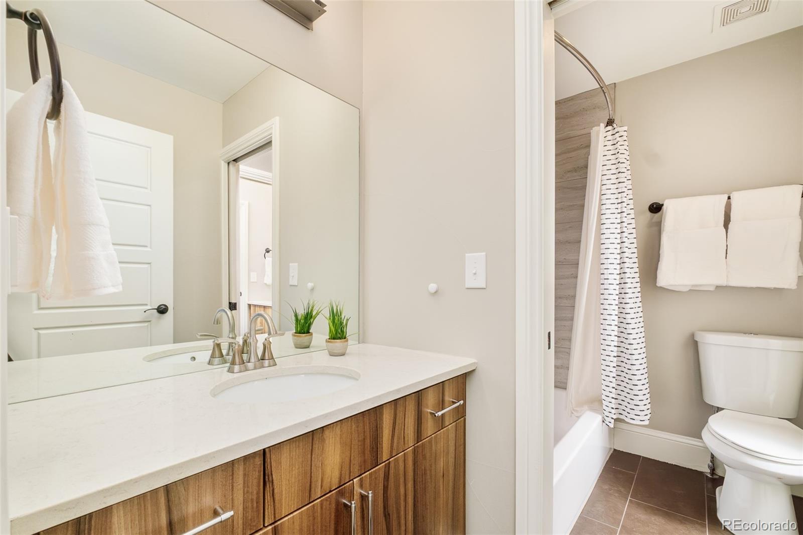 3864 Osceola Street Denver, CO 80212 - Photo 34 of 43 a bathroom with a sink and a mirror