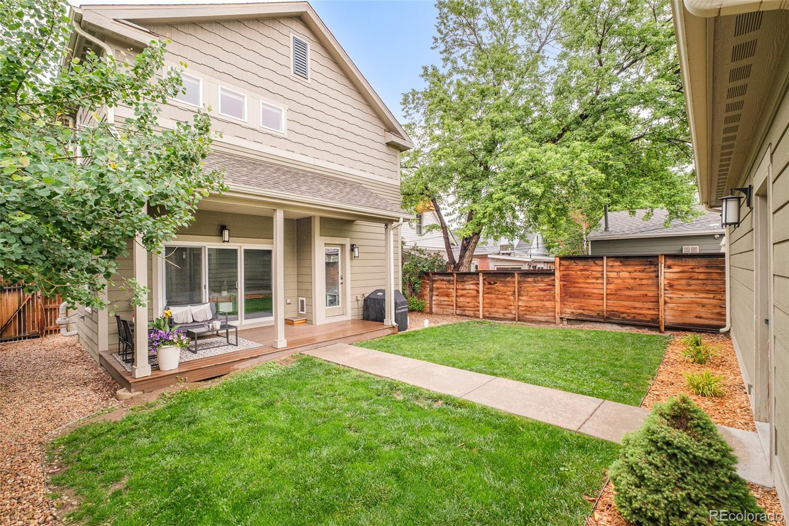 3864 Osceola Street Denver, CO 80212 - Photo 41 of 43 a view of a backyard with table and chairs and wooden fence
