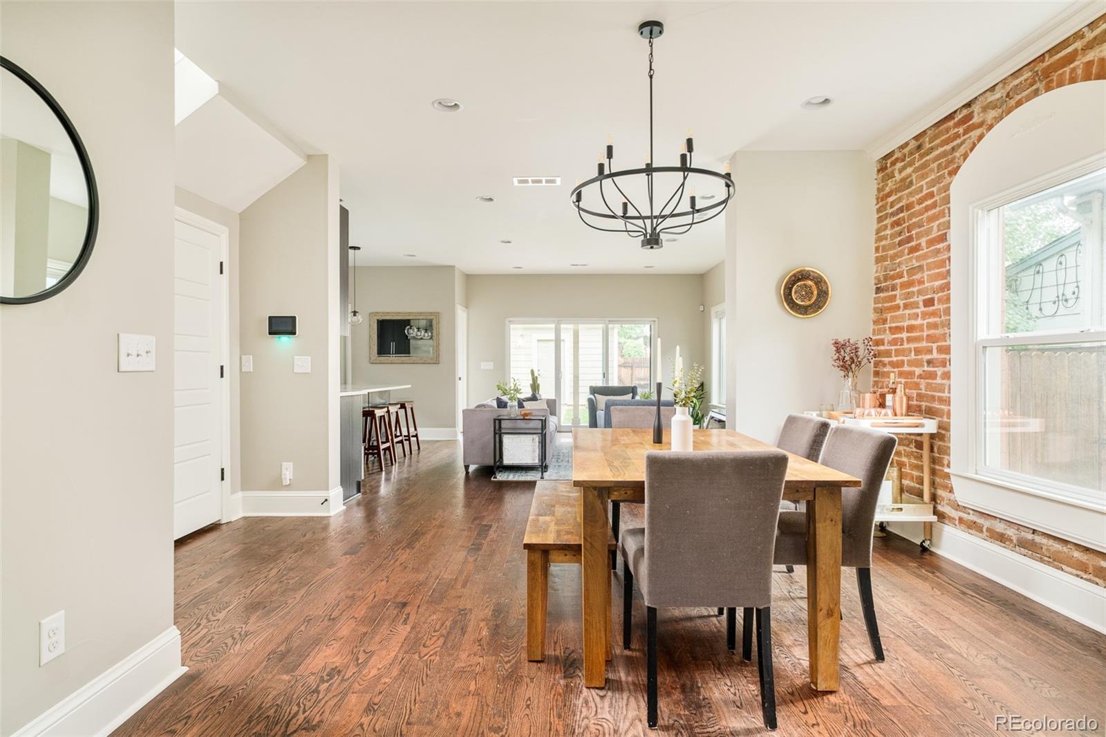 3864 Osceola Street Denver, CO 80212 - Photo 7 of 43 a view of a dining room with furniture window and wooden floor