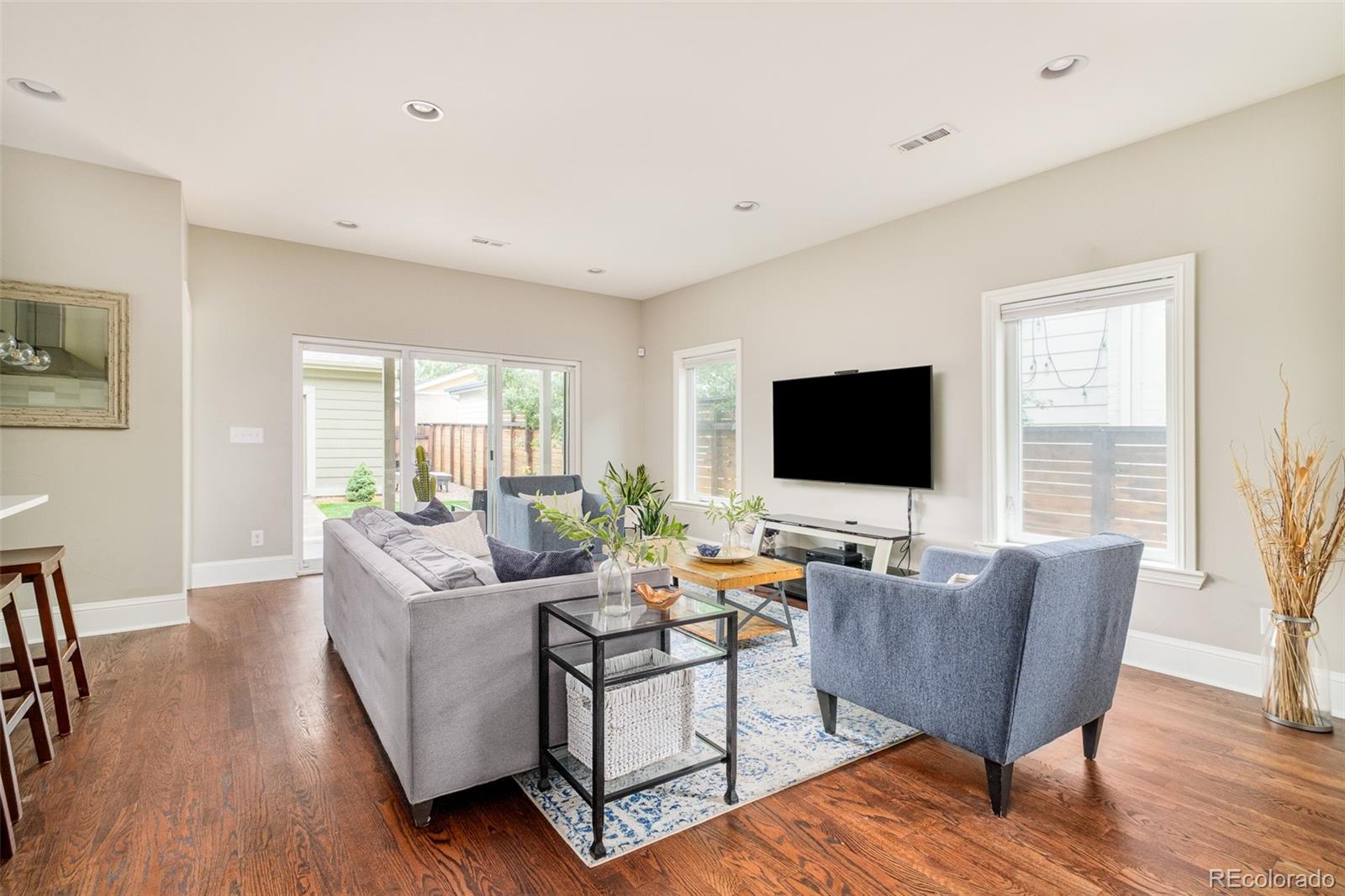 3864 Osceola Street Denver, CO 80212 - Photo 10 of 43 a living room with furniture wooden floor and a flat screen tv