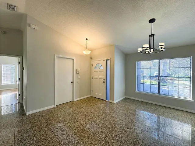 a view of an empty room with a window