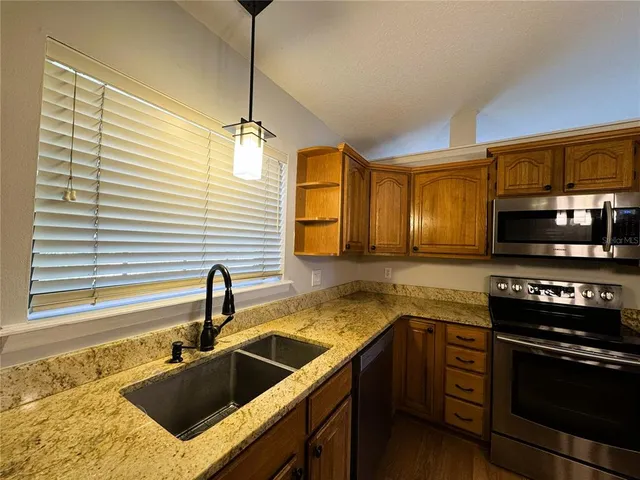 a kitchen that has a sink and a stove