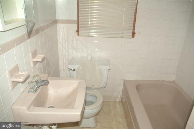 5808 Meridale Road Catonsville, MD 21228 - Photo 3 of 9 a bathroom with a sink a toilet and bathtub