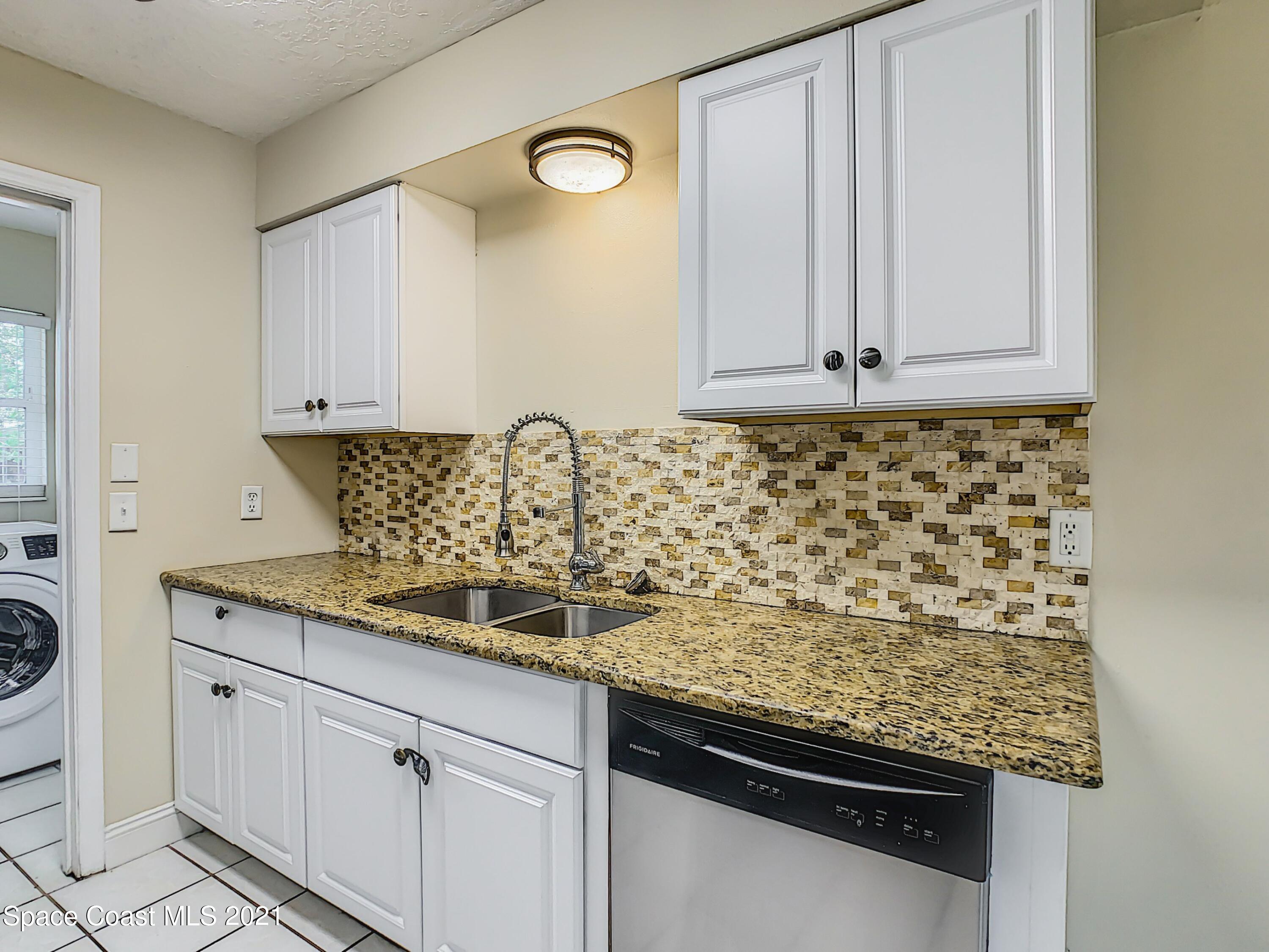1091 Madrid Road Rockledge, FL 32955 - Photo 12 of 33 a kitchen with granite countertop cabinets and window