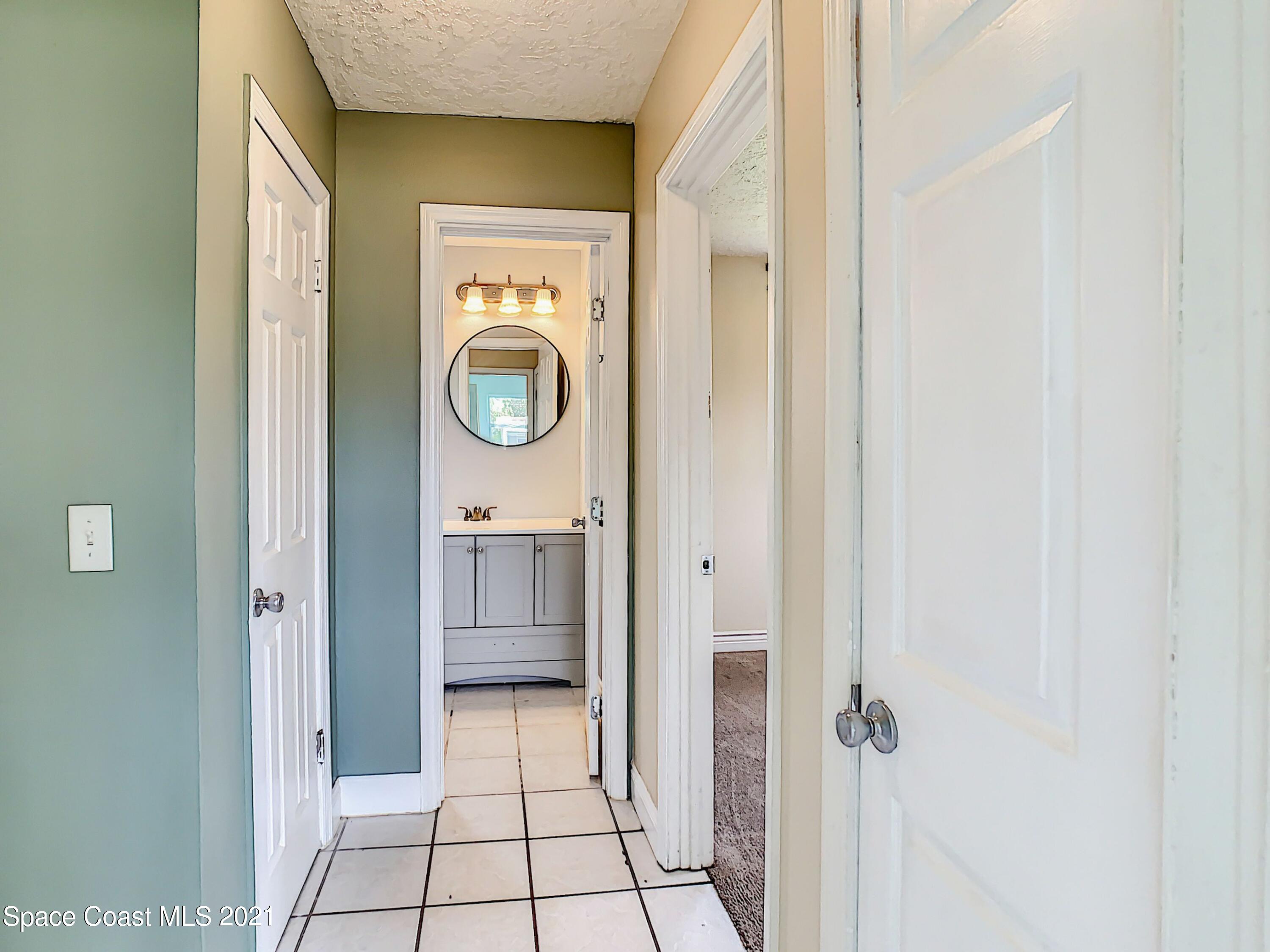 1091 Madrid Road Rockledge, FL 32955 - Photo 18 of 33 a view of a hallway with washer and dryer