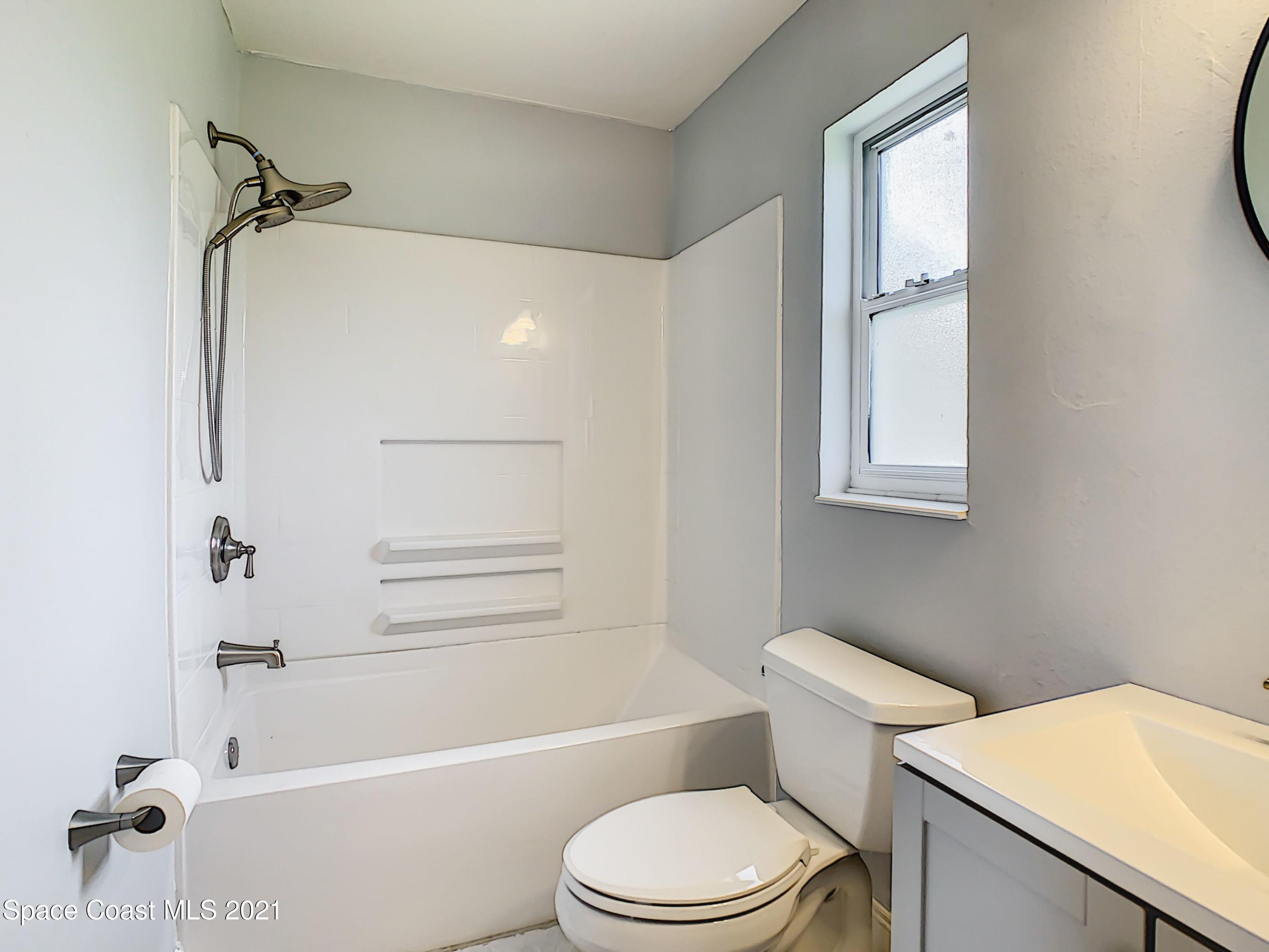 1091 Madrid Road Rockledge, FL 32955 - Photo 20 of 33 a bathroom with a toilet and a bathtub