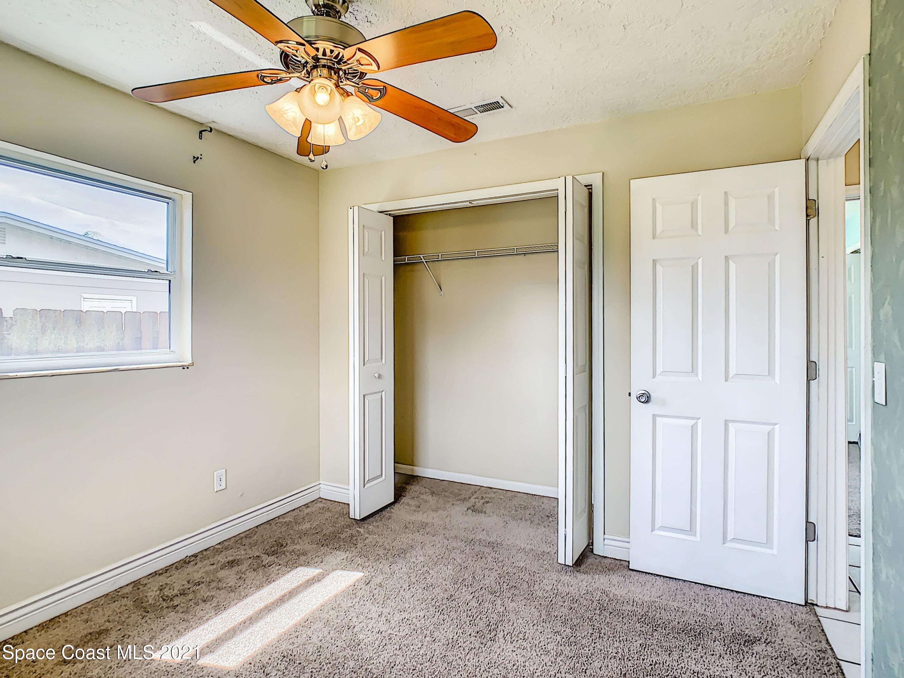 1091 Madrid Road Rockledge, FL 32955 - Photo 21 of 33 a view of a livingroom with a chandelier fan