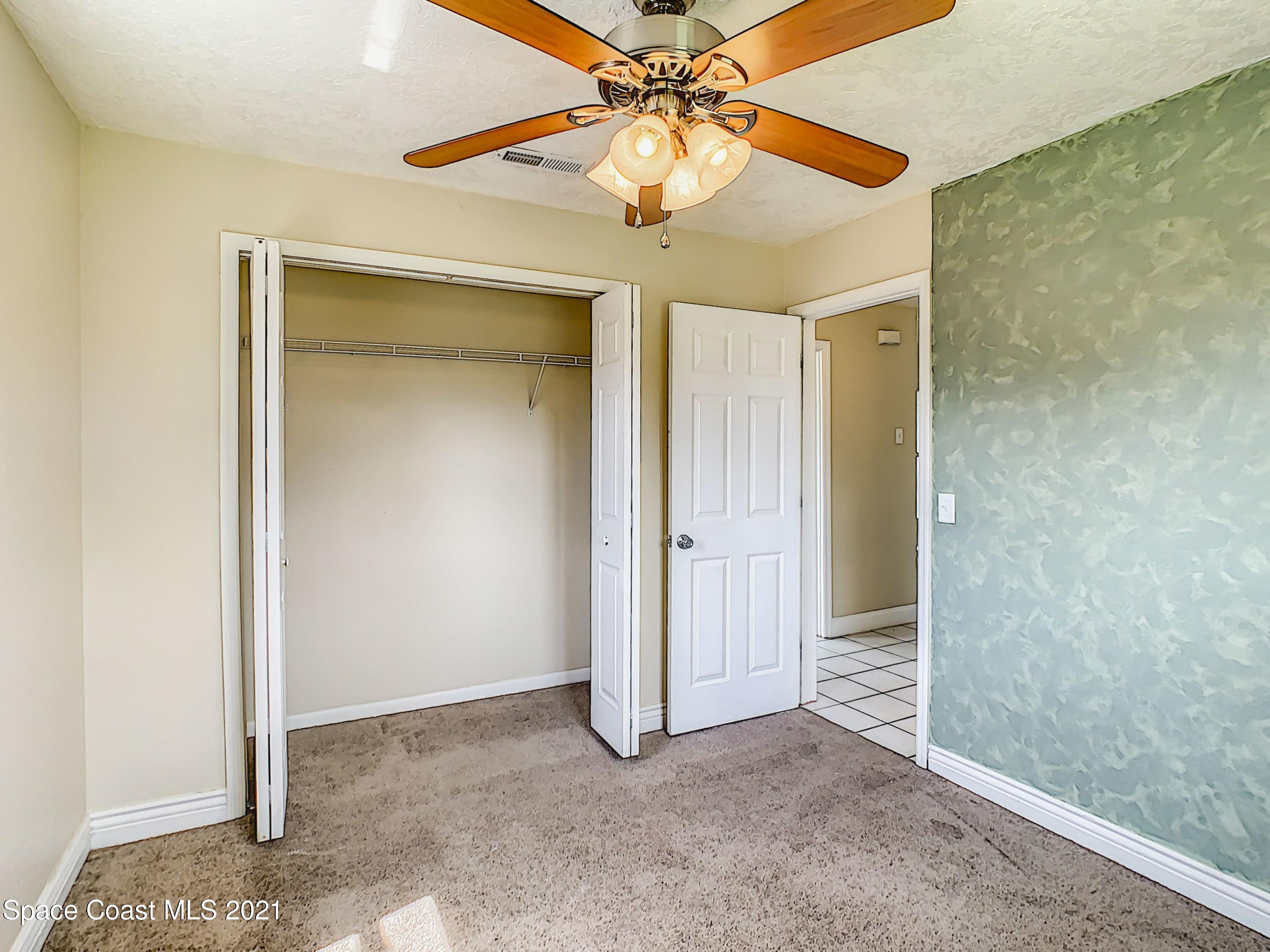 1091 Madrid Road Rockledge, FL 32955 - Photo 22 of 33 an empty room and chandelier fan