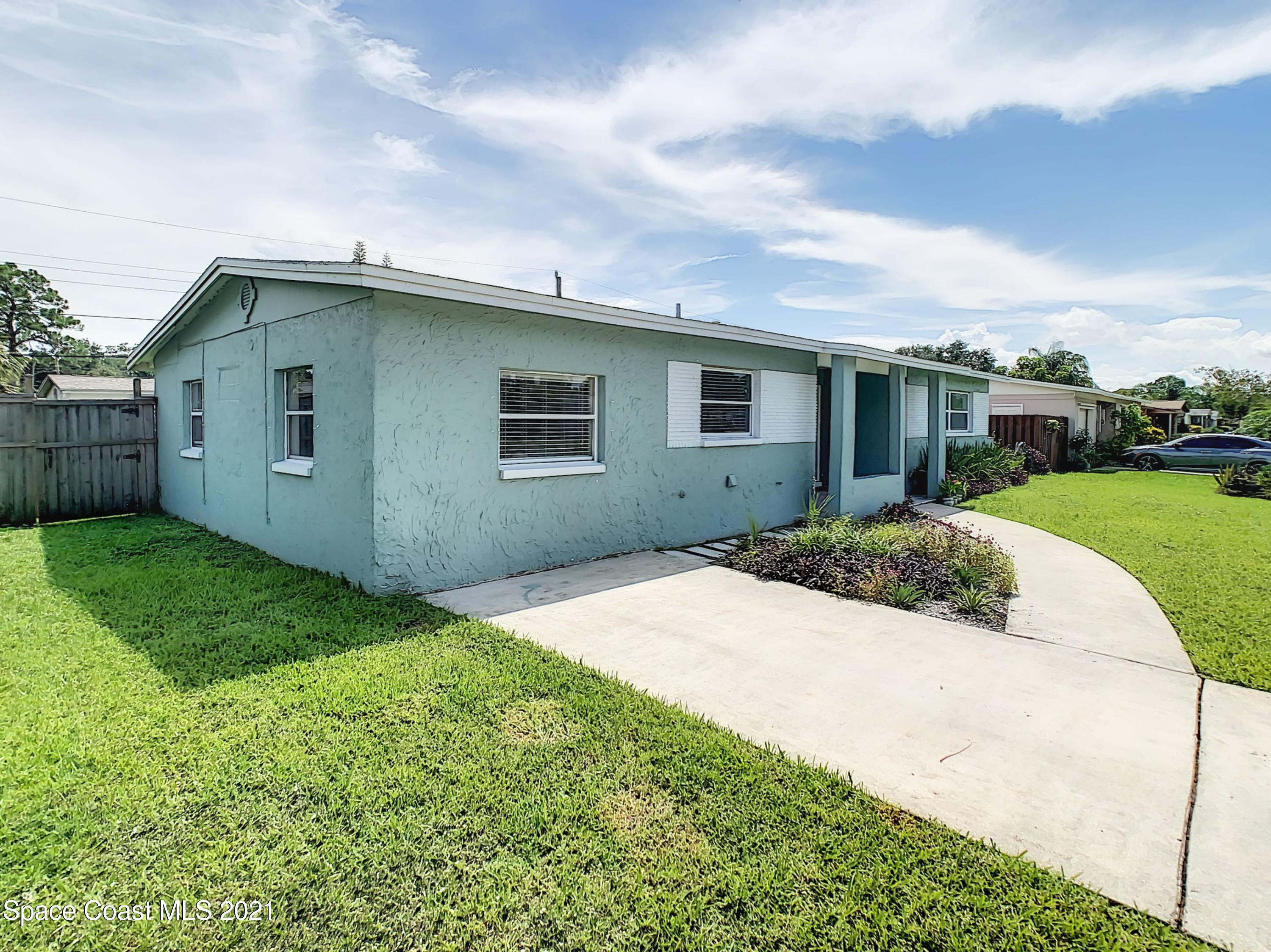 1091 Madrid Road Rockledge, FL 32955 - Photo 24 of 33 a front view of house with yard and green space