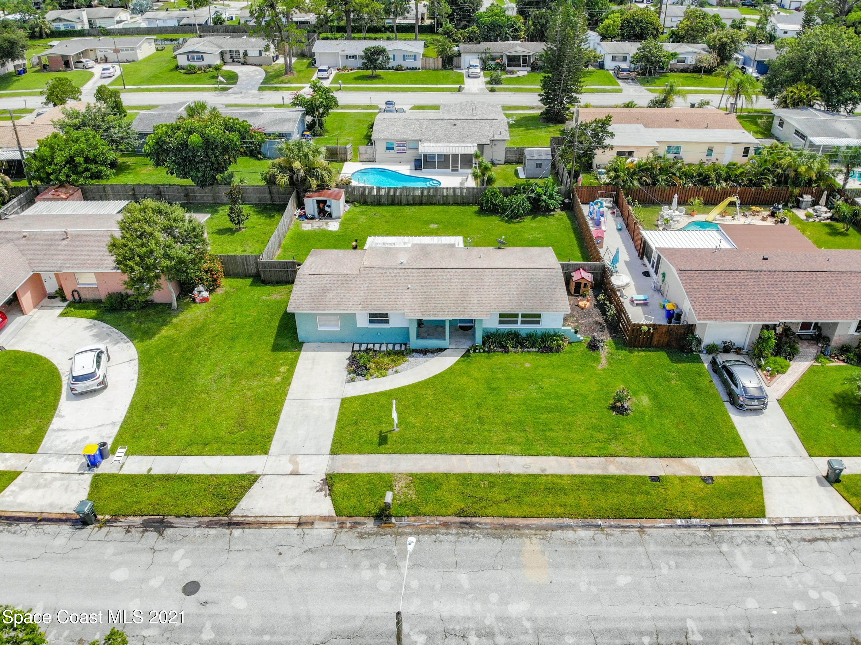 1091 Madrid Road Rockledge, FL 32955 - Photo 28 of 33 an aerial view of a pool yard and lake view