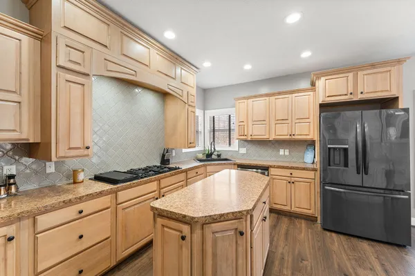 a kitchen with a sink stove and refrigerator