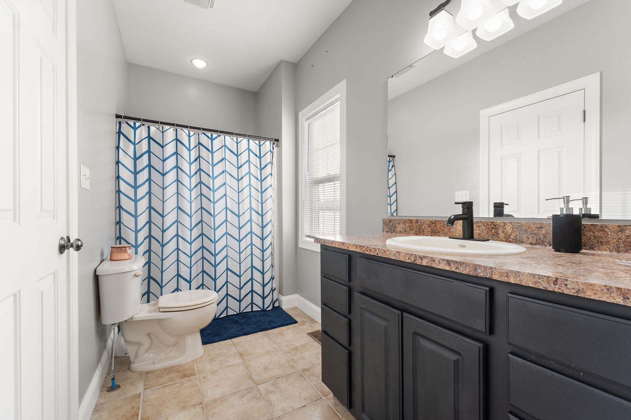 6776 Fox Crossing Knox, IN 46534 - Photo 23 of 53 a bathroom with a granite countertop sink toilet and a mirror