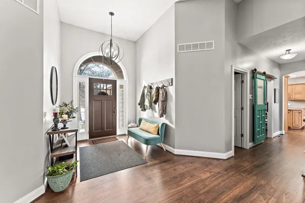 a view of a livingroom with furniture and hallway