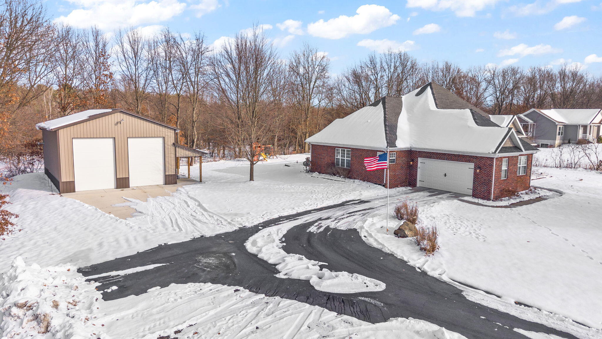 6776 Fox Crossing Knox, IN 46534 - Photo 33 of 53 a front view of a house with a yard covered in snow