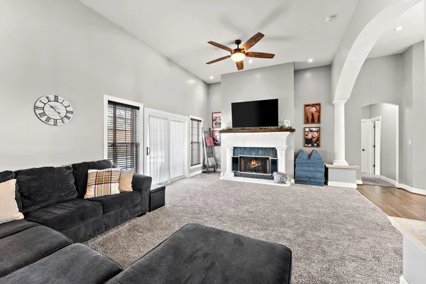 a living room with furniture fireplace and flat screen tv