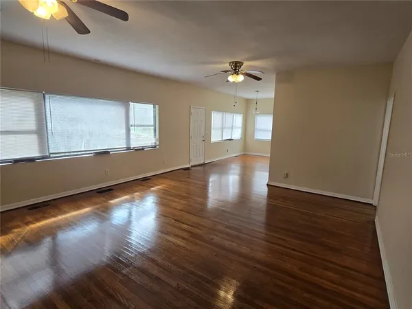 wooden floor in an empty room with a window
