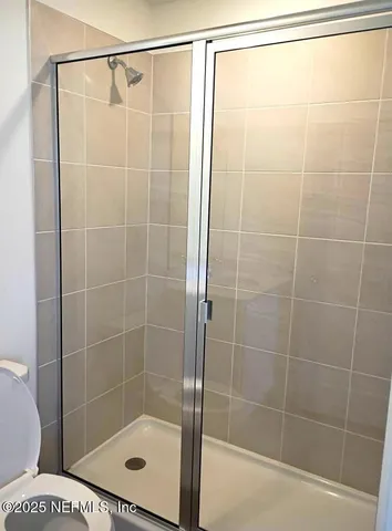 a bathroom with a shower and a toilet