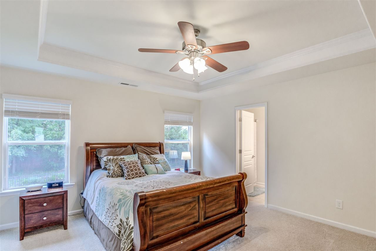 3604 Althorp Drive Raleigh, NC 27616 - Photo 17 of 30 Spacious owner's suite has trey ceiling with crown molding, ceiling fan, view of the natural area behind the home and a spacious ensuite bath. Owner's Suite